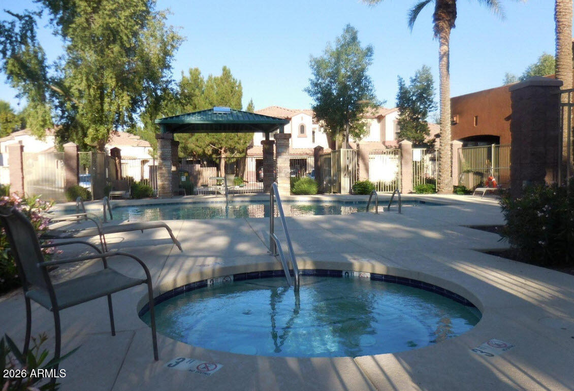 2600 East Springfield Place, Unit 109 Chandler, AZ 85286 - Photo 31 of 38 a view of a swimming pool with a patio