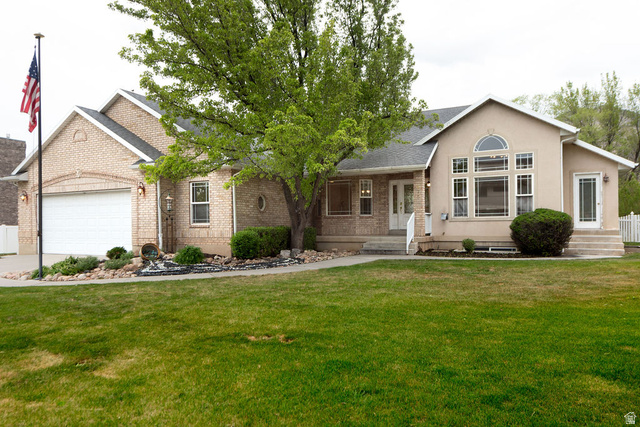 875 East 1300th Street North Mapleton, UT 84664 - Photo 3 of 65 View of front of home with a front lawn, a garage, roof with shingles, and stucco siding