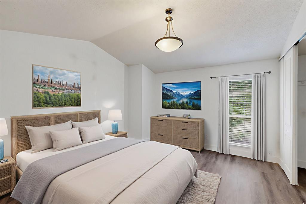 46 Abbey Road Euless, TX 76039 - Photo 14 of 16 Bedroom featuring wood finished floors and lofted ceiling