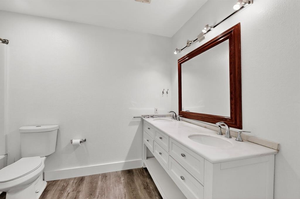 46 Abbey Road Euless, TX 76039 - Photo 6 of 16 Bathroom with double vanity and light wood finished floors