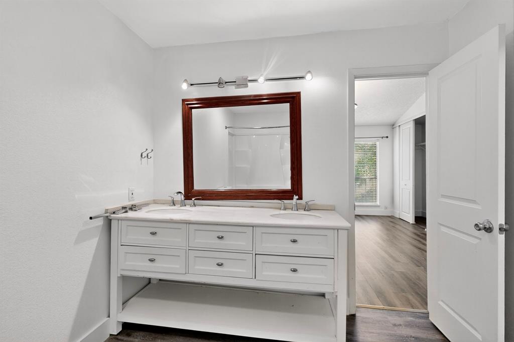 46 Abbey Road Euless, TX 76039 - Photo 7 of 16 Full bathroom with double vanity, dark wood-type flooring, and a shower