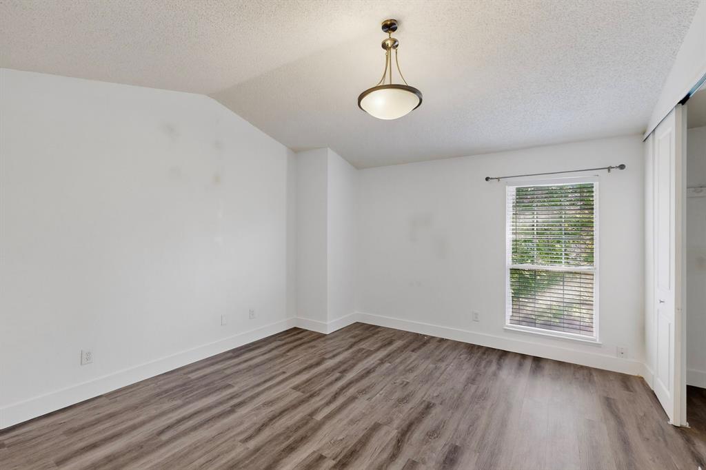 46 Abbey Road Euless, TX 76039 - Photo 8 of 16 Unfurnished room with baseboards and wood finished floors