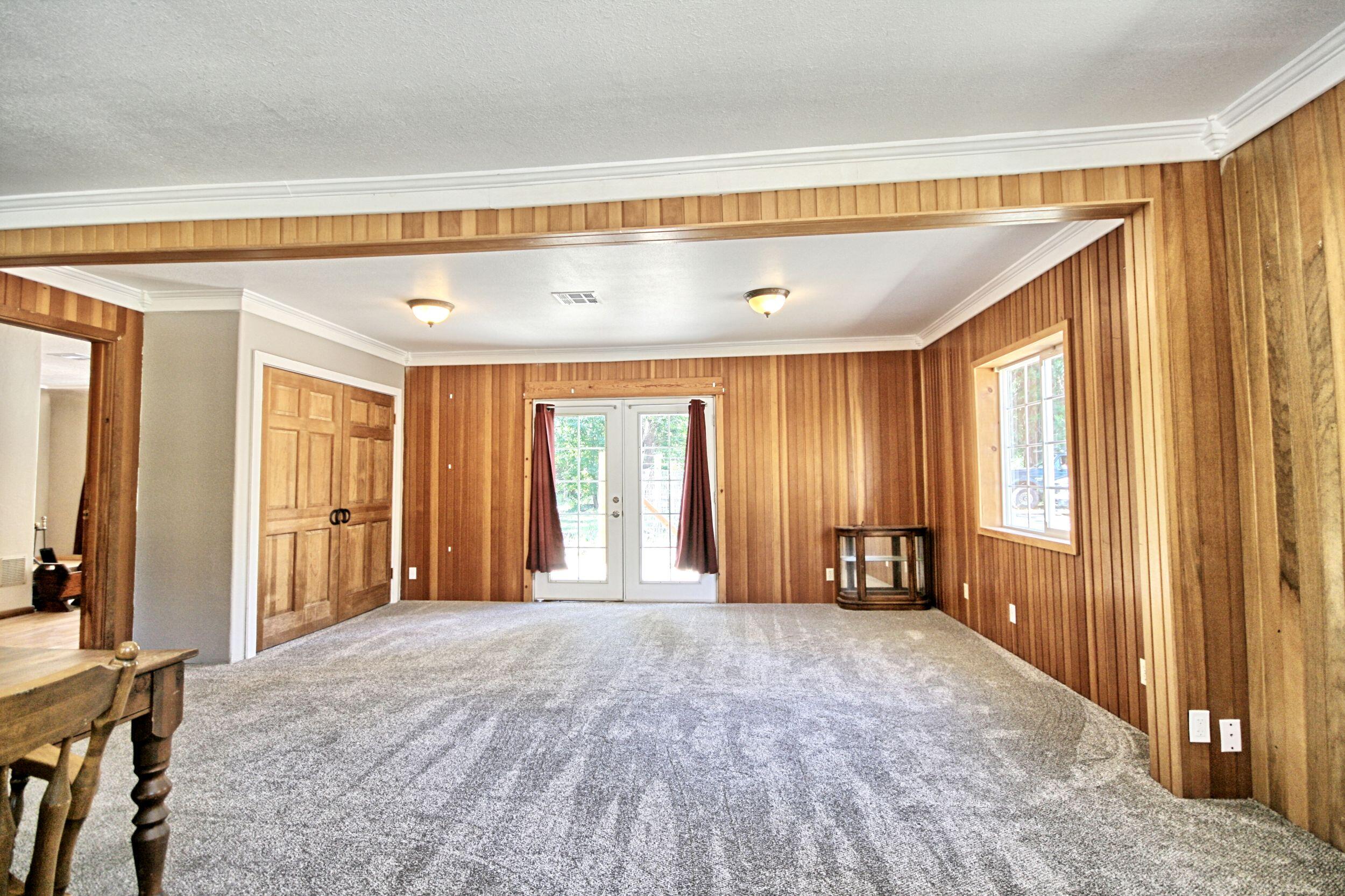 199 Powell Creek Road Williams, OR 97544 - Photo 26 of 57 a view of an empty room with window and a bedroom