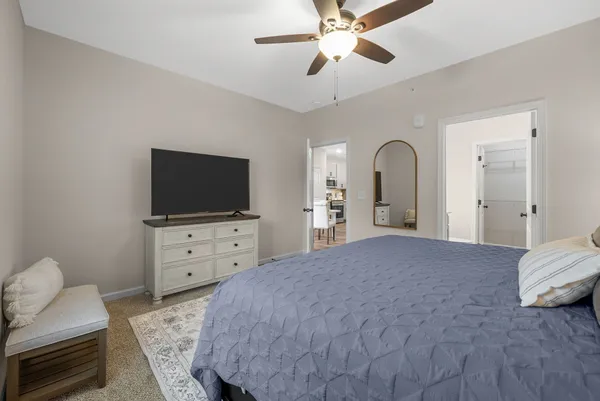 a bedroom with a bed and a flat screen tv