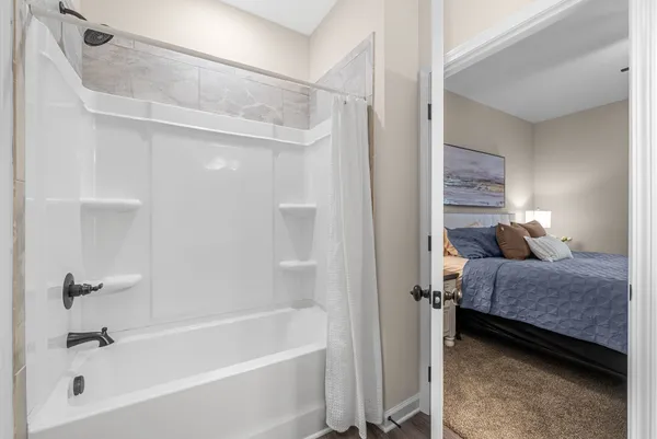 a bathroom with a tub and a shower