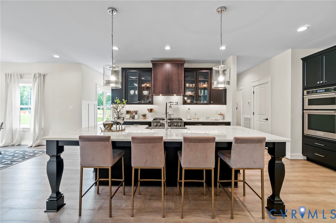4891 Gooden Trail Quinton, VA 23141 - Photo 19 of 52 Kitchen with light wood-type flooring, glass inser