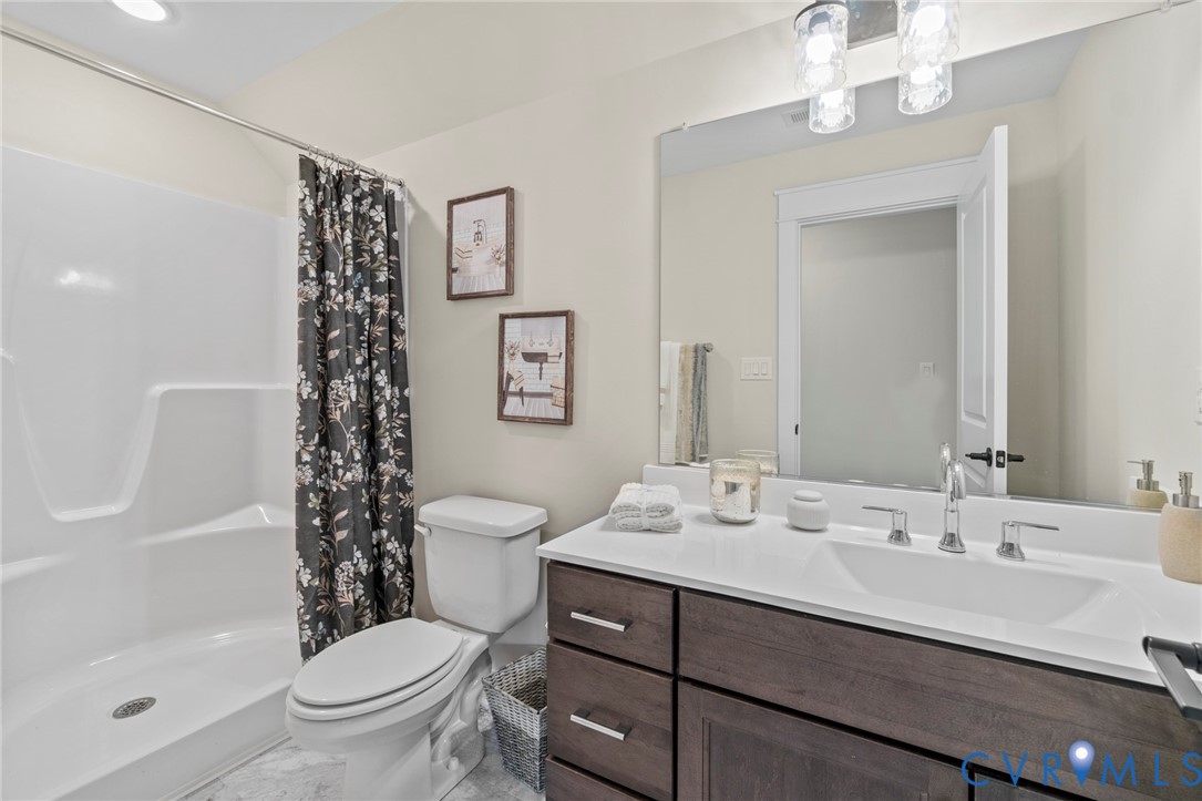 4891 Gooden Trail Quinton, VA 23141 - Photo 34 of 52 Bathroom featuring curtained shower, vanity, and a
