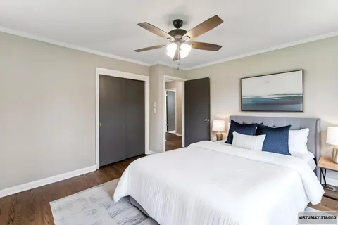 a bedroom with a large bed and a chandelier