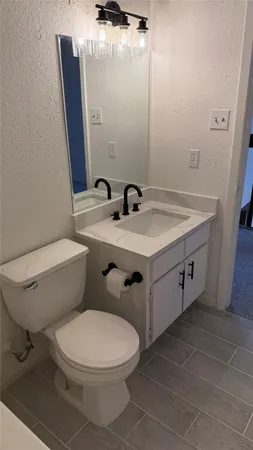 a view of a bathroom from a corridor