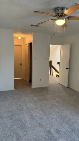 a view of an empty room and a window
