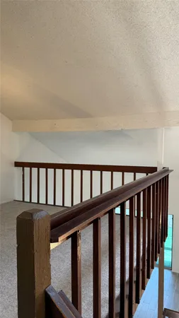 a view of staircase with a floor to ceiling window and a sink