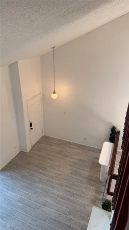 a view of an empty room and wooden floor