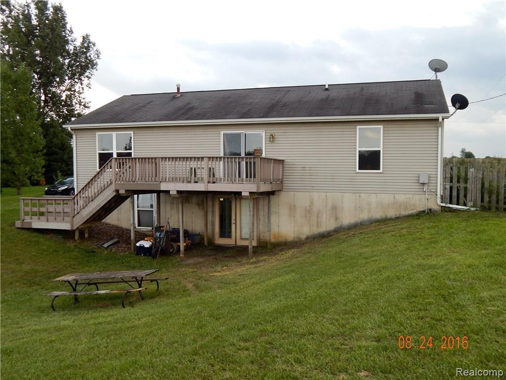 9792 Judd Road Fowlerville, MI 48836 - Photo 12 of 21 Back of home with Trex Deck and walk out