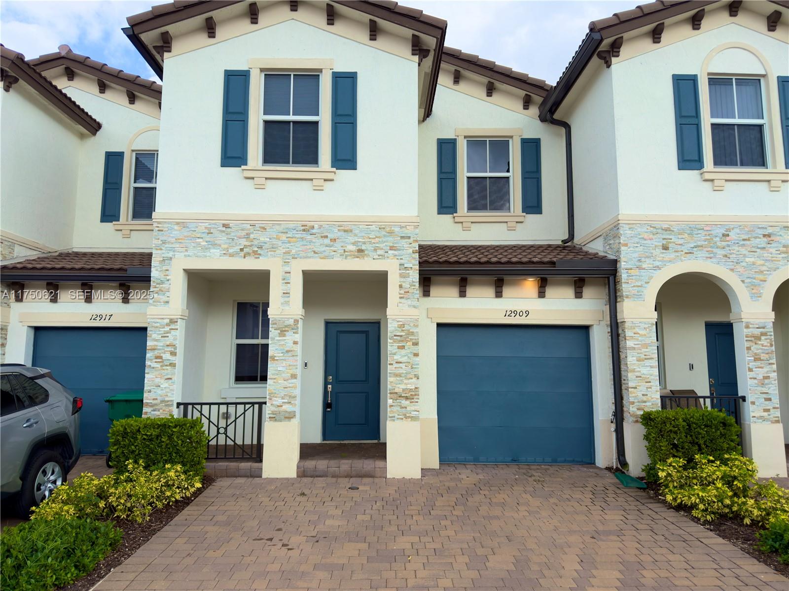 12909 Northwest 23rd Place, Unit 12909 Miami, FL 33167 - Photo 11 of 34 a front view of a house with yard and parking