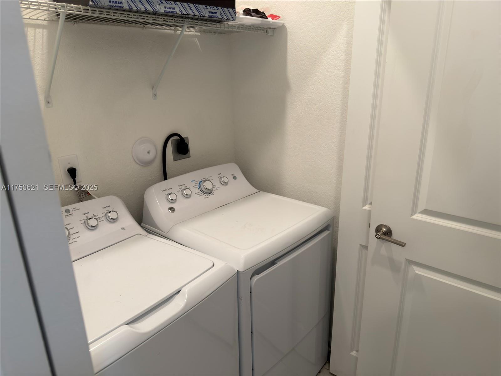 12909 Northwest 23rd Place, Unit 12909 Miami, FL 33167 - Photo 18 of 34 a utility room with dryer and washer