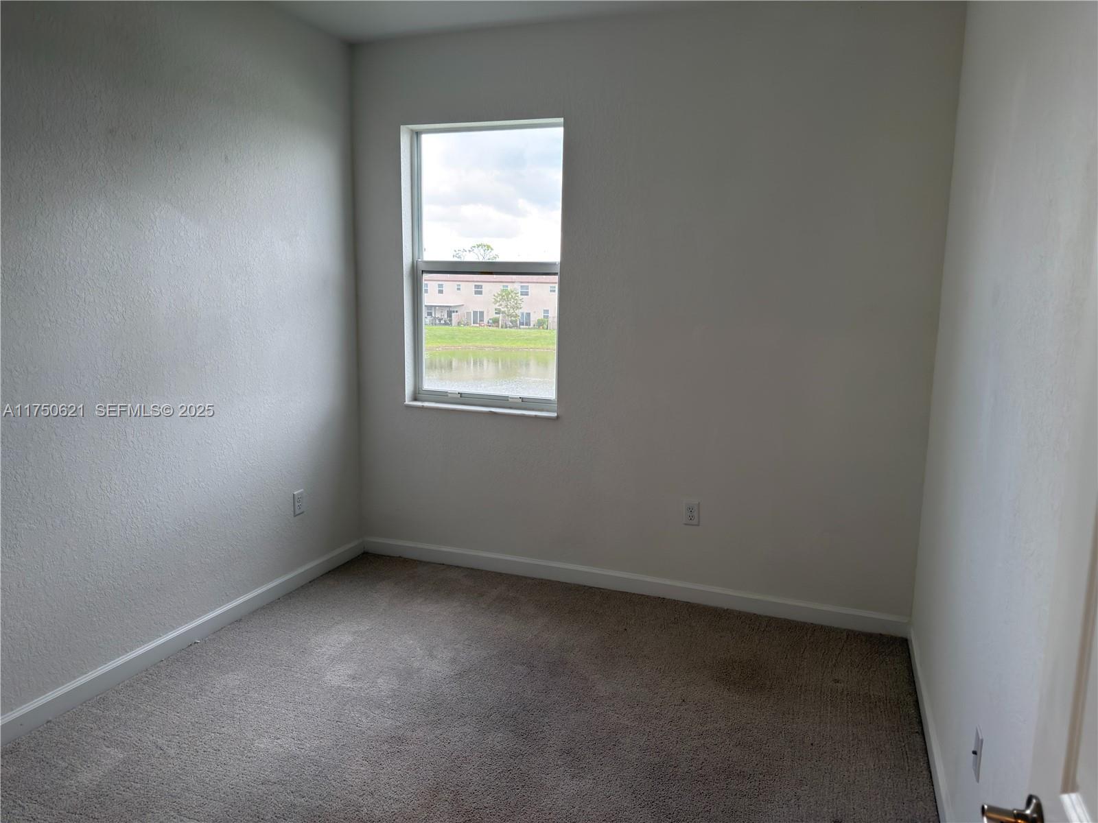 12909 Northwest 23rd Place, Unit 12909 Miami, FL 33167 - Photo 24 of 34 an empty room with a window