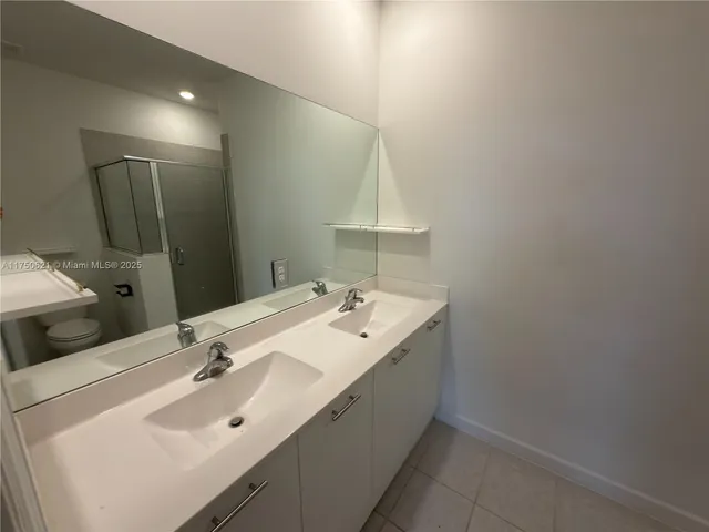 a bathroom view of a toilet and a shower