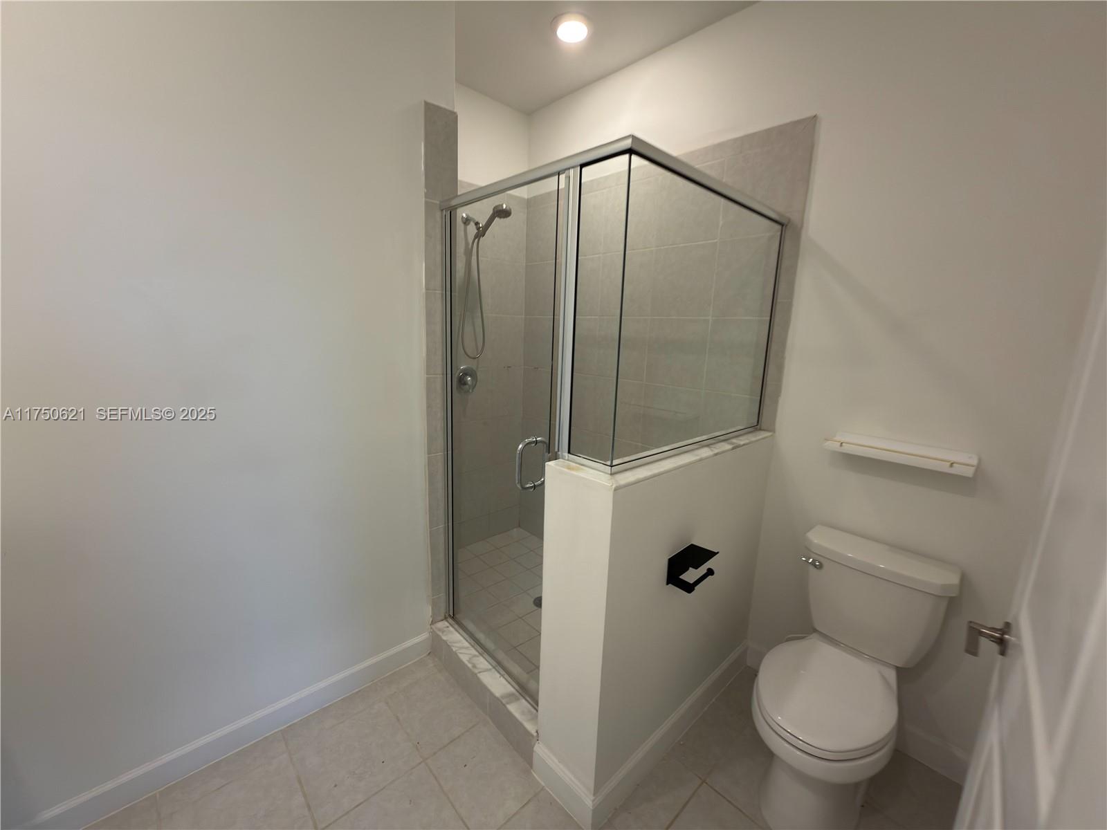 12909 Northwest 23rd Place, Unit 12909 Miami, FL 33167 - Photo 26 of 34 a bathroom view of a toilet and a shower