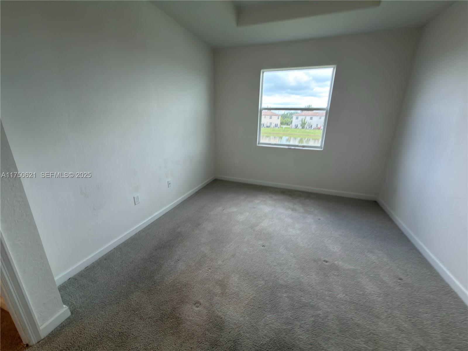 12909 Northwest 23rd Place, Unit 12909 Miami, FL 33167 - Photo 28 of 34 an empty room with a window