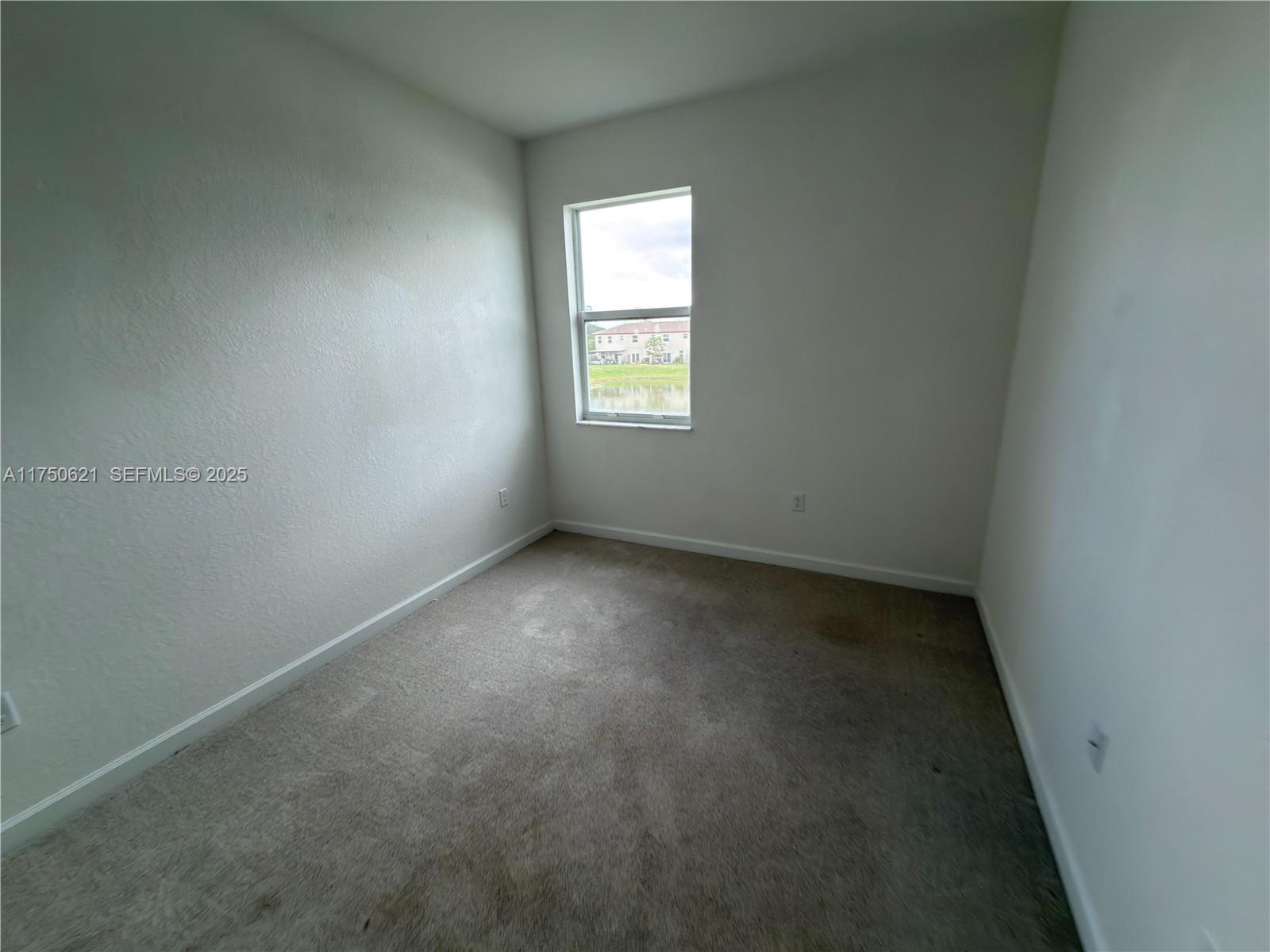12909 Northwest 23rd Place, Unit 12909 Miami, FL 33167 - Photo 29 of 34 an empty room with a window