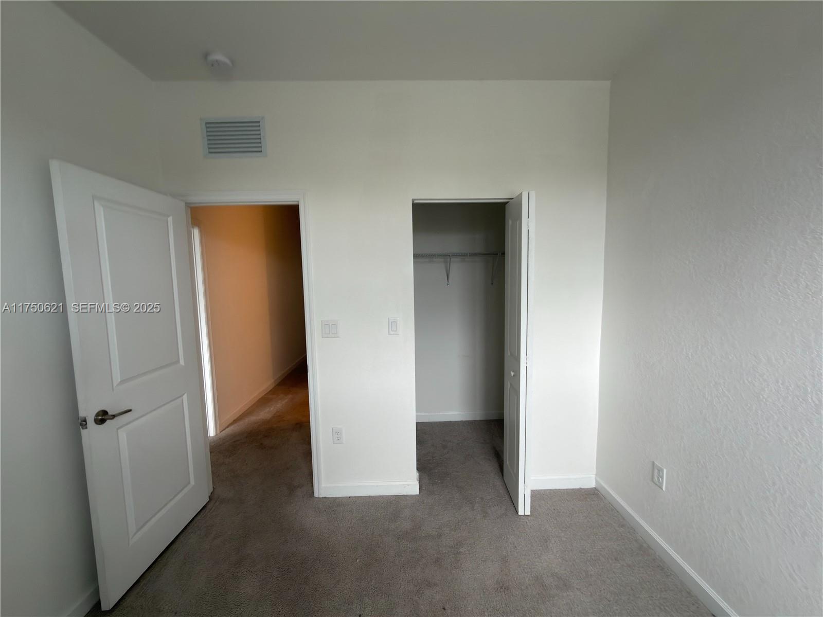 12909 Northwest 23rd Place, Unit 12909 Miami, FL 33167 - Photo 30 of 34 an empty room with closet