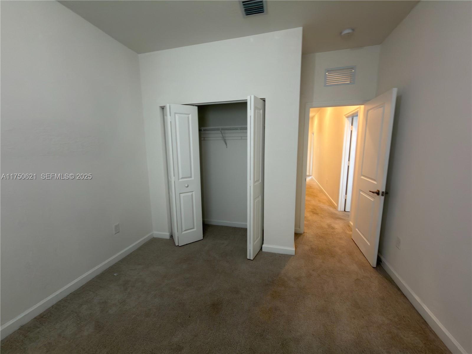 12909 Northwest 23rd Place, Unit 12909 Miami, FL 33167 - Photo 34 of 34 an empty room with windows