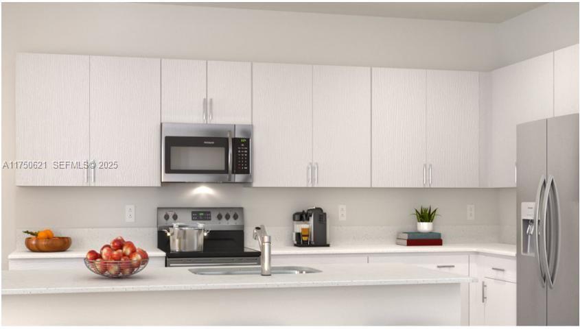 12909 Northwest 23rd Place, Unit 12909 Miami, FL 33167 - Photo 8 of 34 a kitchen with a cabinets and a fireplace