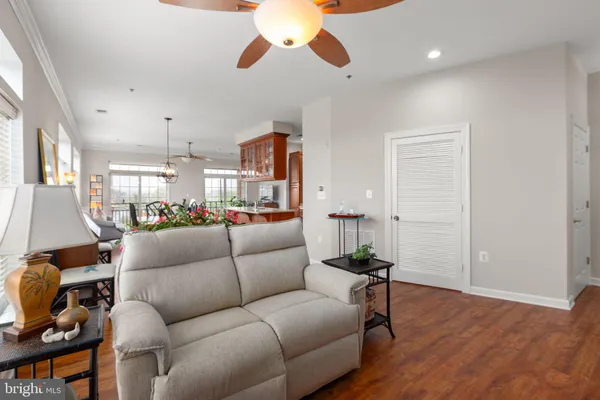 a living room with furniture a window and a potted plant