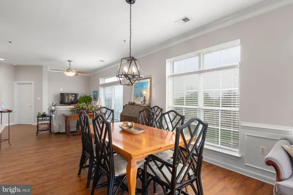 a dining room filled with furniture and a chandelier
