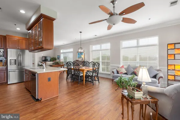 a living room with furniture a dining table and a fireplace