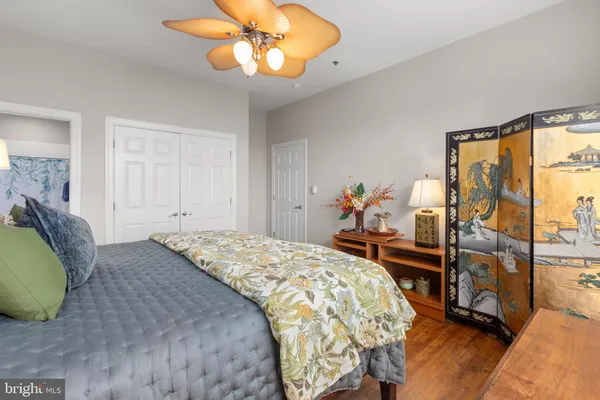 a bedroom with a bed and wooden floor