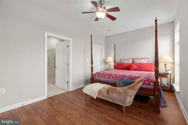 a bedroom with a bed and wooden floor