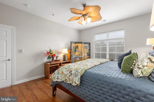 a bedroom with a bed and wooden floor