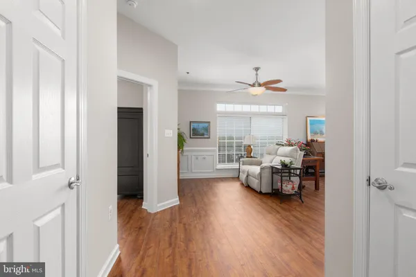 a view of a hallway with wooden floor and entryway