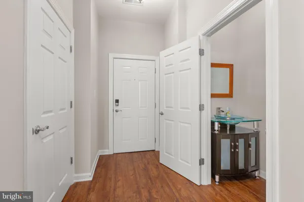 a view of a hallway with wooden floor