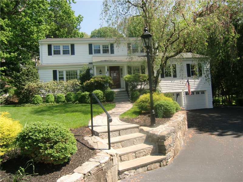 2 Revere Road Riverside, CT 06878 - Photo 1 of 13 a front view of a house with a yard and porch