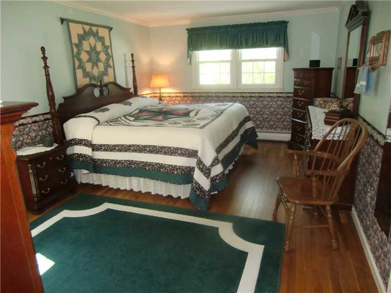 2 Revere Road Riverside, CT 06878 - Photo 10 of 13 a bed sitting in a bedroom next to a window