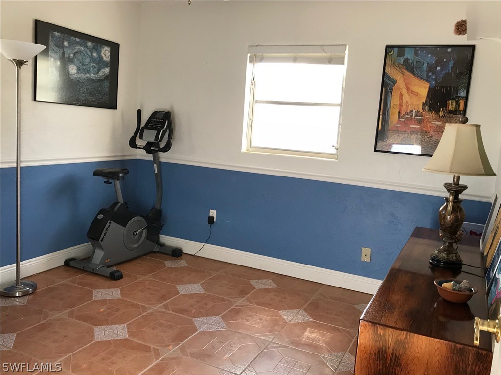 1439 Collins Road Fort Myers, FL 33919 - Photo 12 of 20 a room with a window and a painting on the wall