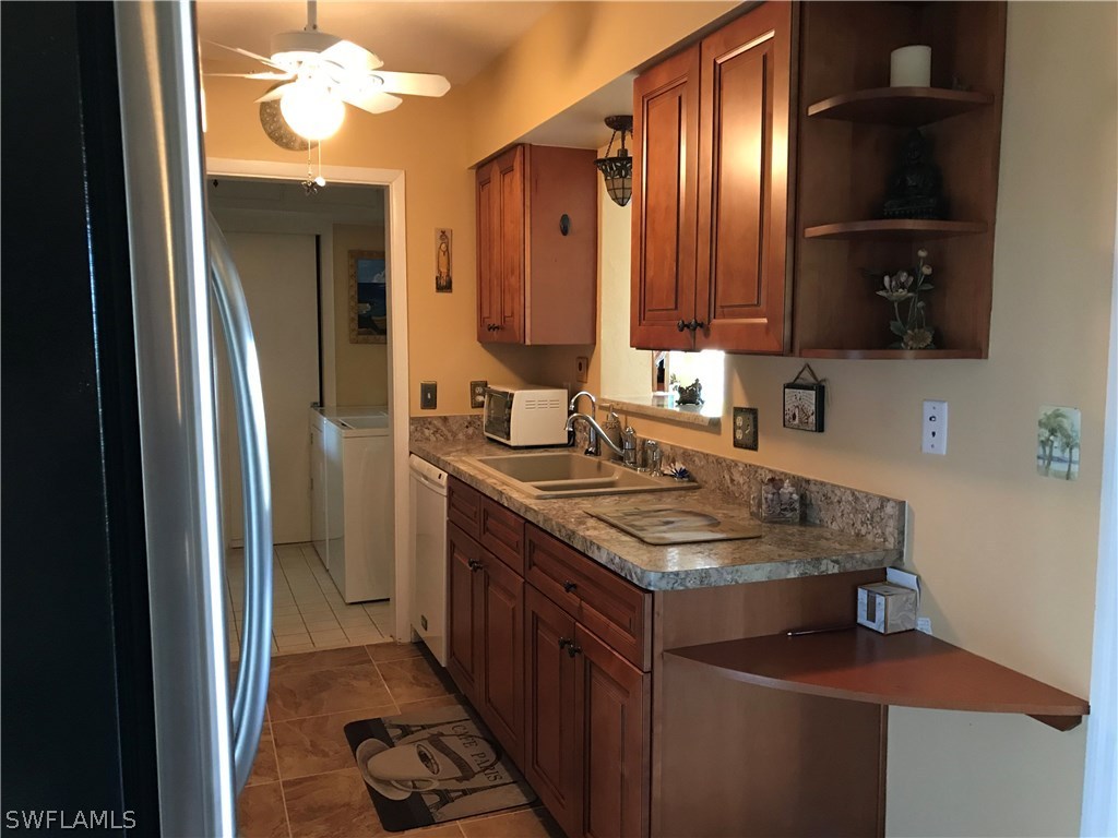 1439 Collins Road Fort Myers, FL 33919 - Photo 2 of 20 a bathroom with a sink and a mirror