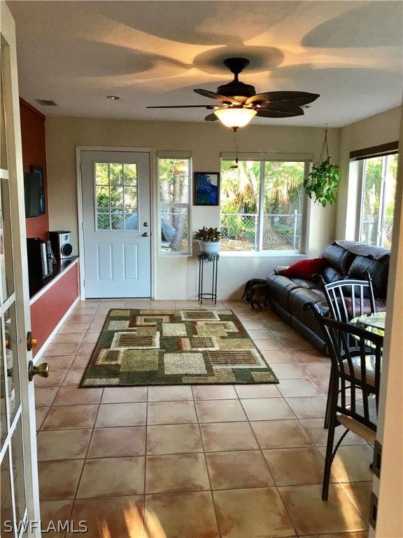 1439 Collins Road Fort Myers, FL 33919 - Photo 6 of 20 a living room with patio furniture and a large window