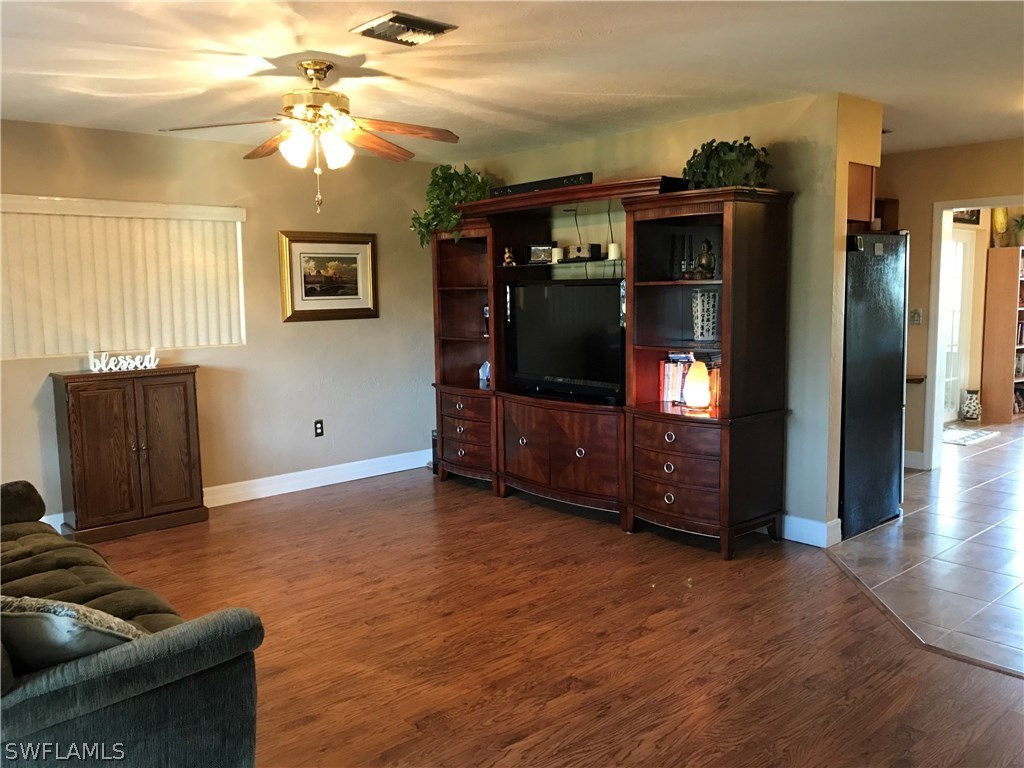1439 Collins Road Fort Myers, FL 33919 - Photo 8 of 20 a living room with furniture and a flat screen tv