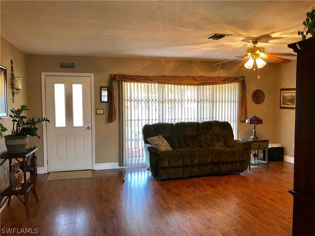 1439 Collins Road Fort Myers, FL 33919 - Photo 9 of 20 a living room with furniture and a chandelier