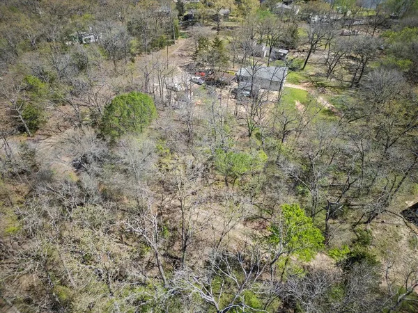 a aerial view of a yard with a tree