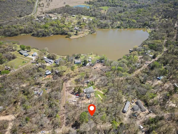 an aerial view of a house with a lake view