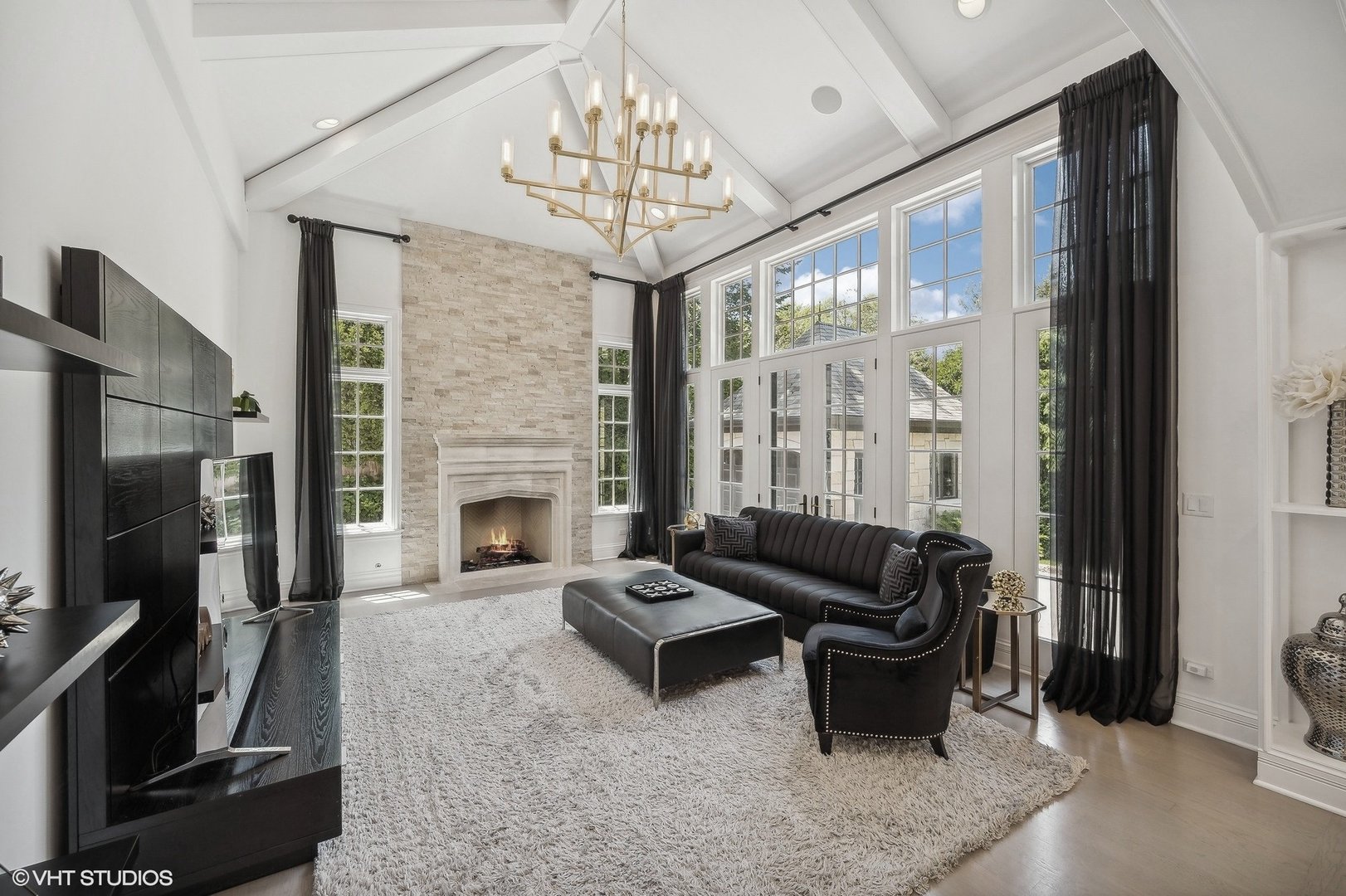 67 Beach Road Glencoe, IL 60022 - Photo 12 of 43 a living room with furniture a fireplace and a flat screen tv
