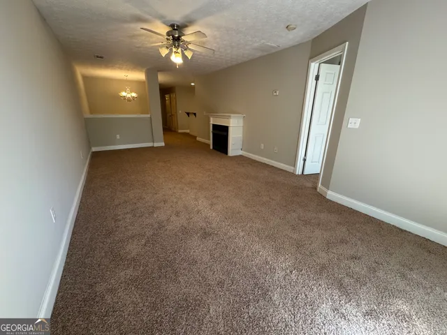 a view of a livingroom with a ceiling fan and window