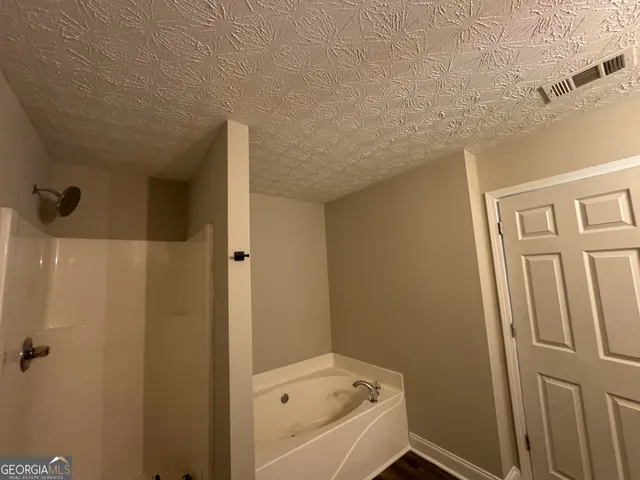 a bathroom with a tub sink and vanity