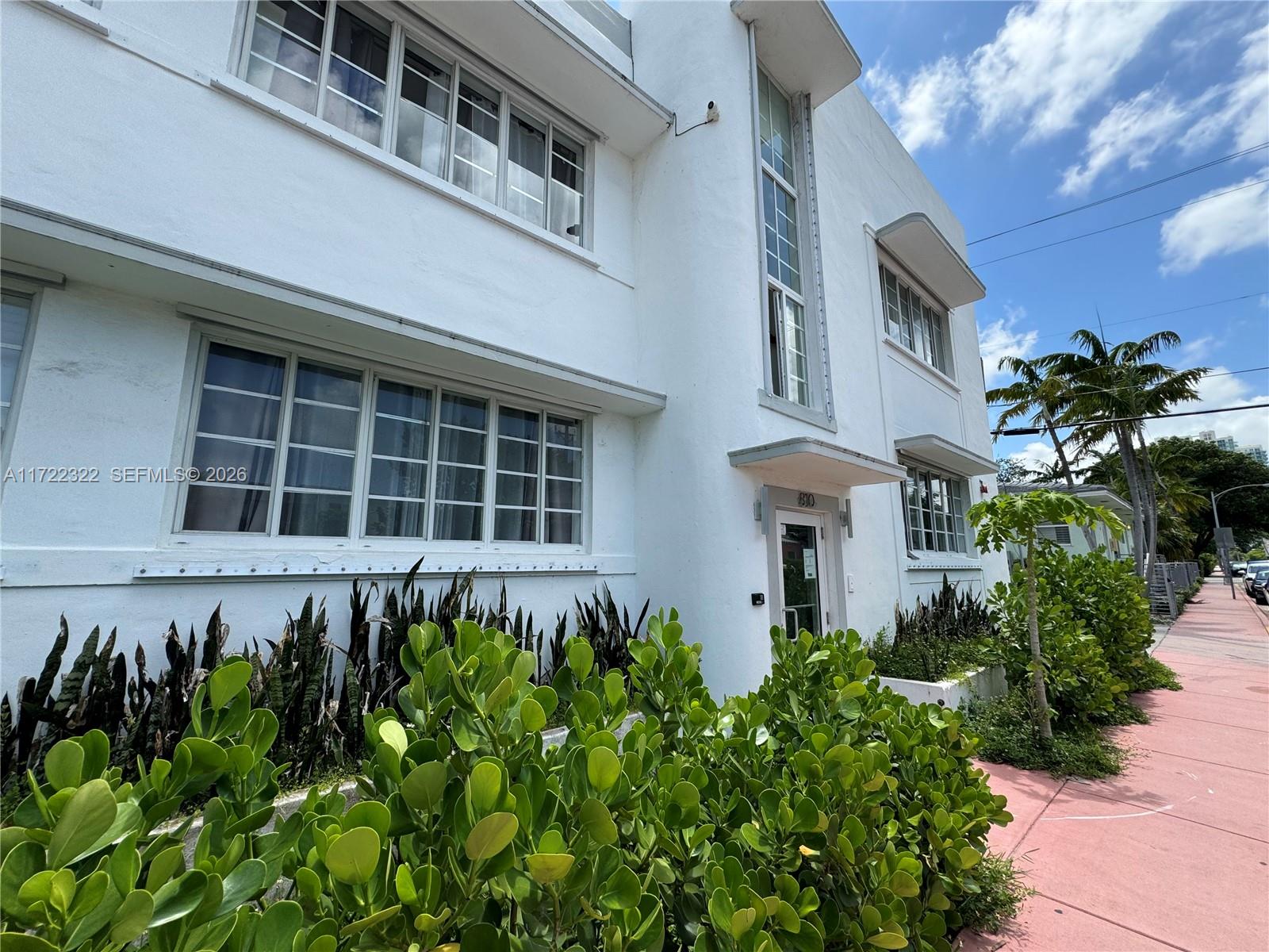 810 7th Street, Unit 207 Miami Beach, FL 33139 - Photo 15 of 16 a front view of a building with a bunch of flowers