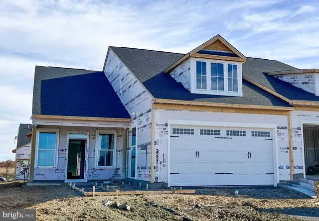 a front view of a house with a wooden fence