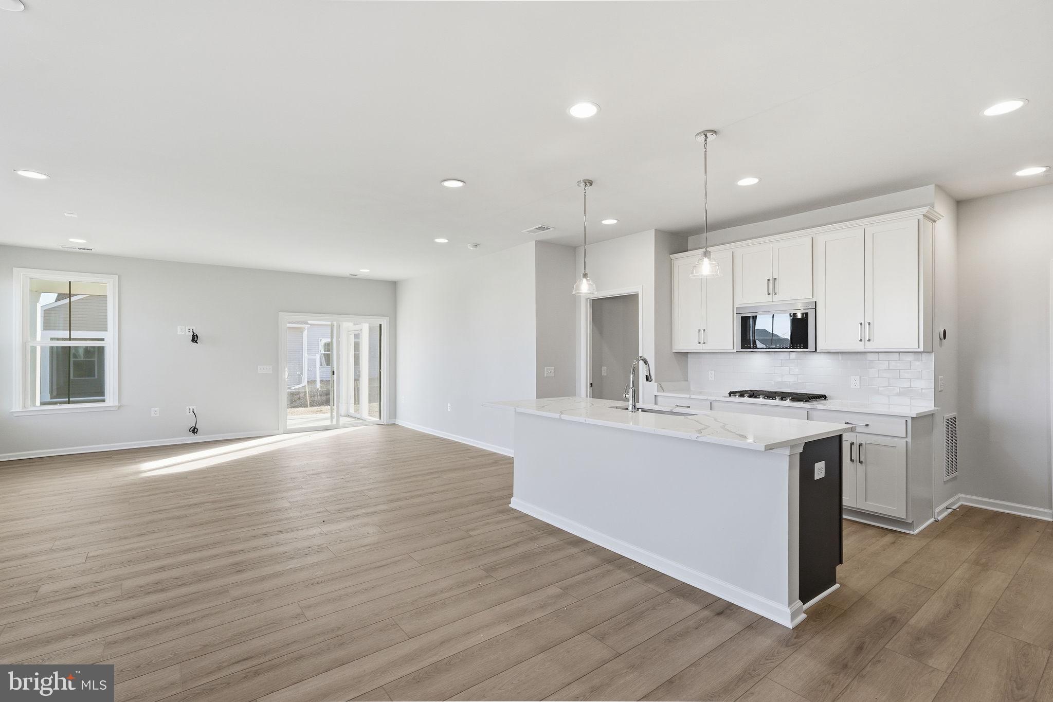110 Carnation Way Winchester, VA 22603 - Photo 6 of 27 a kitchen with kitchen island a sink stainless steel appliances and cabinets